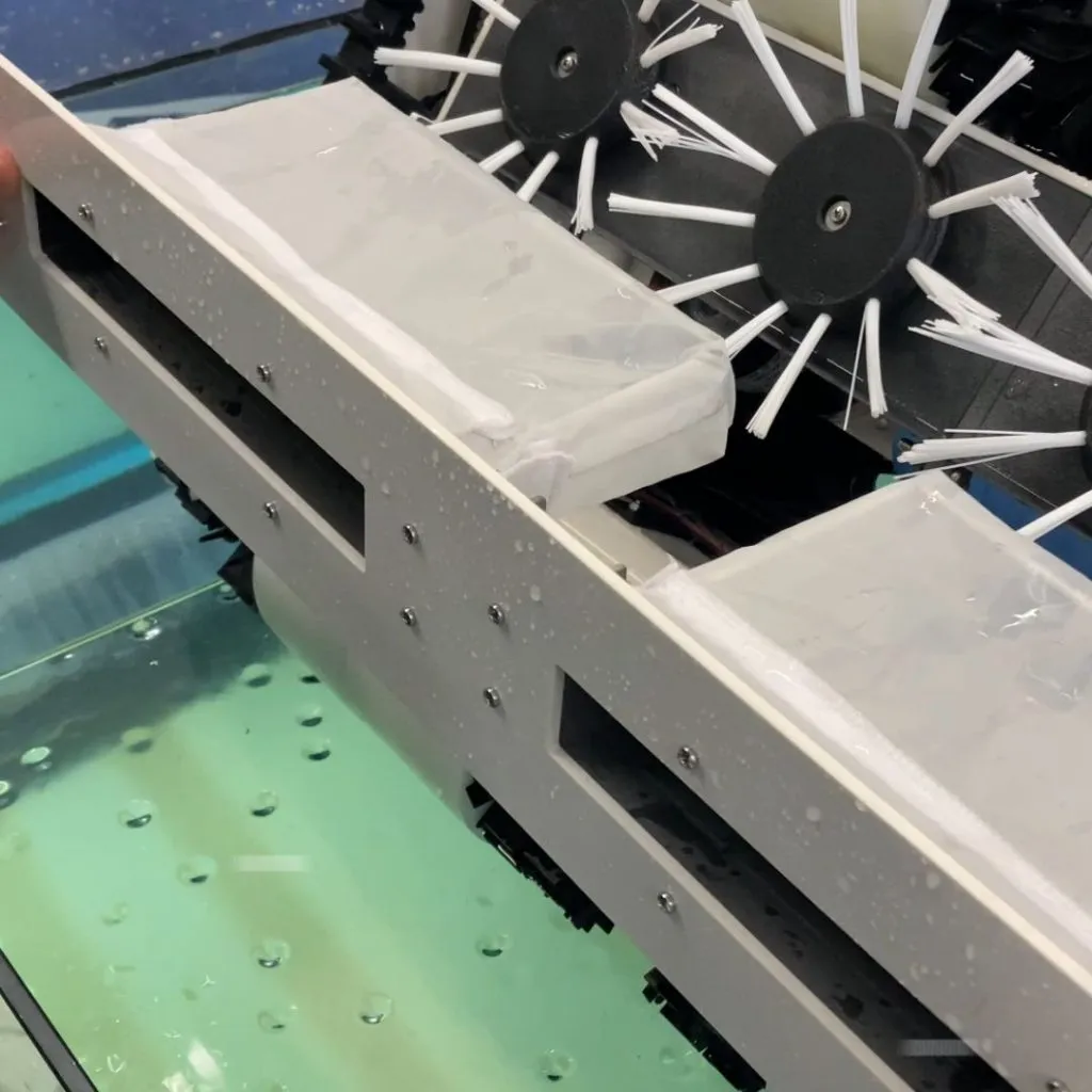 Close-up of counter-rotating cleaning brushes on the drone